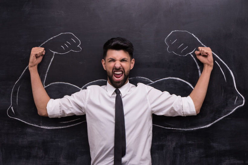 36992991 - funny picture of young businessman ready to win on chalkboard background. two strong muscular arms painted on chalkboard