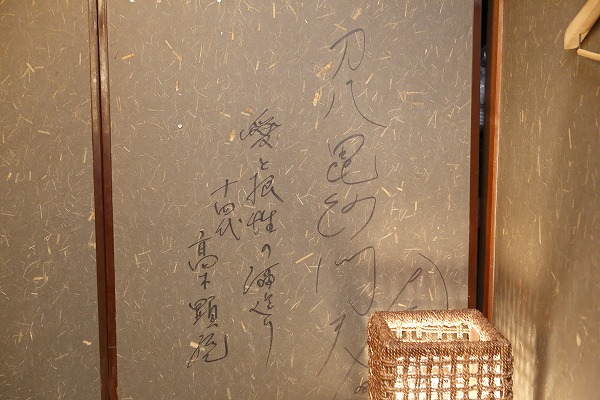 ↑同店2階の襖に書かれた高木顕統氏の一筆。「愛と根性の酒造り」とある