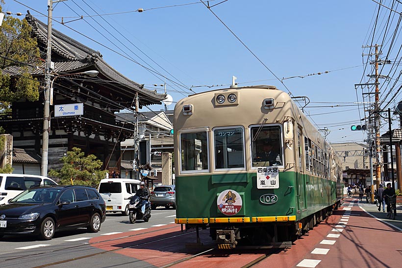 ↑広隆寺の山門前、太秦交差点を走り抜ける嵐電モボ101形。嵐電の形式名の頭にはみな“モボ”が付く