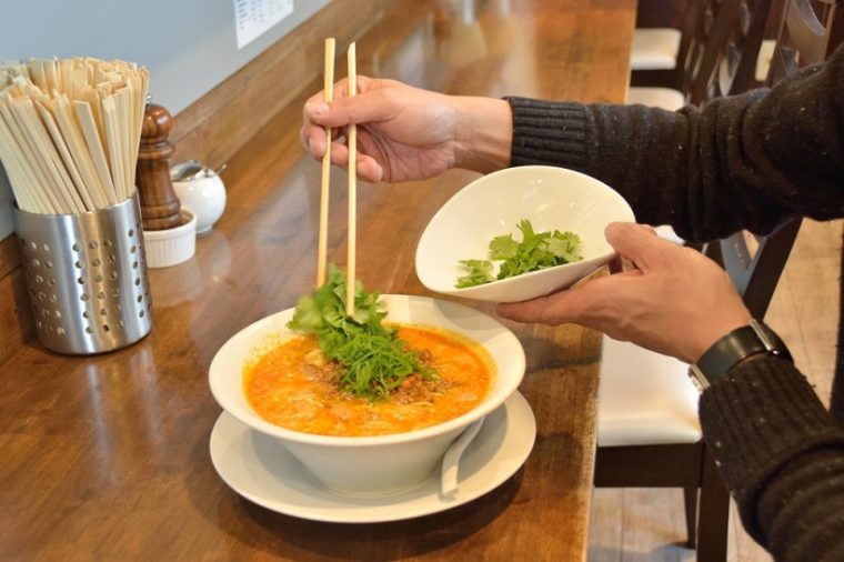 ↑担担麺にパクチーを投入。女性にはパクチー好きが多いから、というのも田中さんが鳴龍を推す理由のひとつです