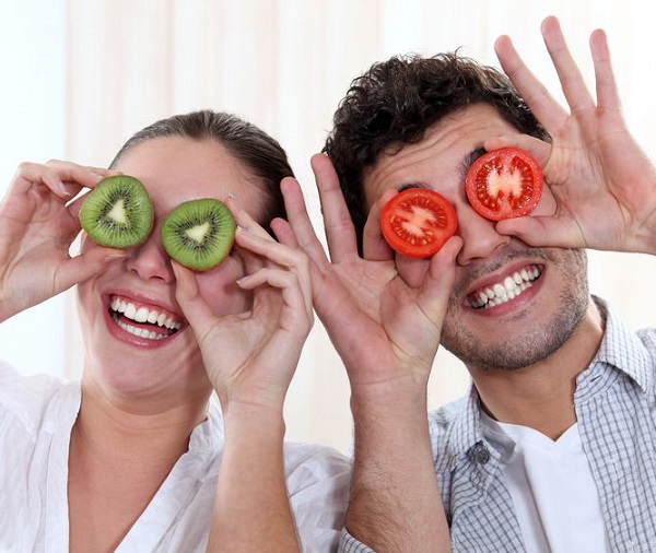 15449146 - funny couple covering their eyes with fruit