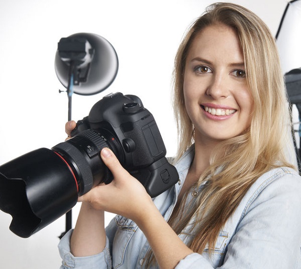 47560822 - female professional photographer working in studio