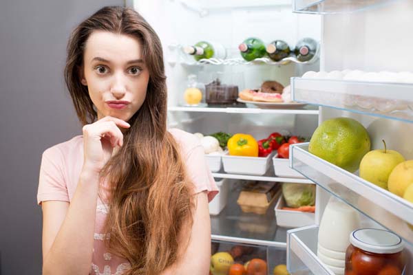 71185646 - woman near the refrigerator