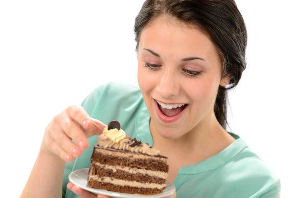 19379785 - joyful young girl eating tasty piece of cake