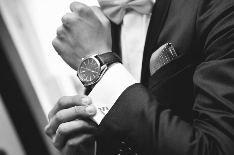 26729597 - man with suit and watch on hand